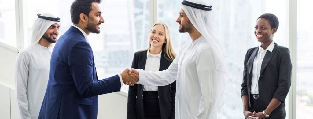 Handshake between Emirati and business professional, symbolizing trust and transparency in gratuity services