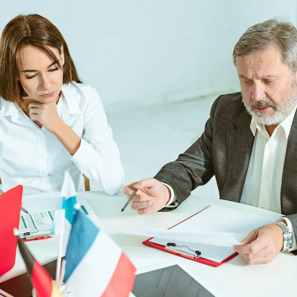 Business professionals reviewing documents in a meeting.